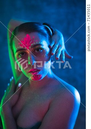 Portrait of woman in colorful neon lighting. 71435011