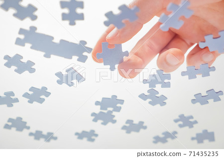 Bottom View. Male Hands Assembling Jigsaw Puzzle. Pastime, a hobby. Complex project management. Playing Calm Board Game. Unfinished Puzzle. Learning Concept. Finding Solution. Task and subtask concept Bottom View. Male Hands Assembling Jigsaw Puzzle. Pastime, a hobby. Complex project management. Playing Calm Board Game. Unfinished Puzzle. Learning Concept. Finding Solution. Task and subtask concept 71435235