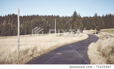 Retro toned picture of a mountain road. Retro toned picture of a mountain road. 71435947