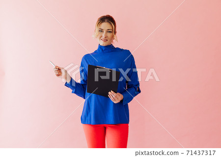 Beautiful business woman of 40 years holds paper Beautiful business woman of 40 years holds paper 71437317