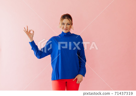 Beautiful woman shows hand symbol ok pink Beautiful woman shows hand symbol ok pink 71437319