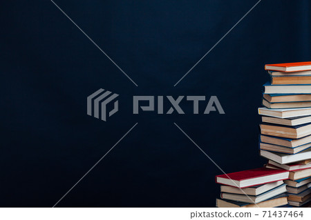 stacks of books for reading and education on a black background in the university library 71437464