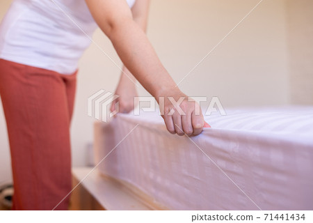 Make a bed,Woman hands making her bed in room after wake up in the morning 71441434