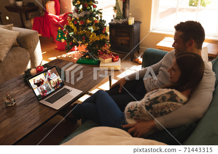 Caucasian couple at christmas on a video call 71443315