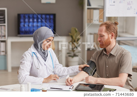 Doctor measuring the pressure Doctor measuring the pressure 71443680