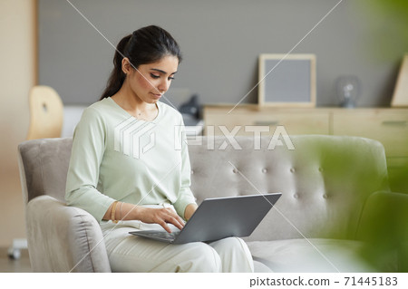Woman using laptop at home Woman using laptop at home 71445183