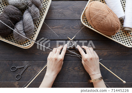 Girl knitting at the table Girl knitting at the table 71445226