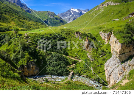 Mountain river and wood bridge in Vanoise national Park valley, French alps Mountain river and wood bridge in Vanoise national Park valley, French alps 71447306