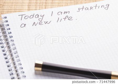 Top view workplace notebook and pen on wood table background, retro effect. The inscription - today I begin a new life. The concept of renewal and lifestyle changes Top view workplace notebook and pen on wood table background, retro effect. The inscription - today I begin a new life. The concept of renewal and lifestyle changes 71447996