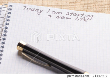 Top view workplace notebook and pen on wood table background, retro effect. The inscription - today I begin a new life. The concept of renewal and lifestyle changes Top view workplace notebook and pen on wood table background, retro effect. The inscription - today I begin a new life. The concept of renewal and lifestyle changes 71447997