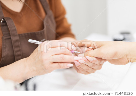 A woman giving a statement at a nail salon A woman giving a statement at a nail salon 71448120