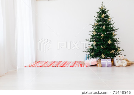 Christmas tree pine with gifts for the new year of the white room 2021 2022 71448546