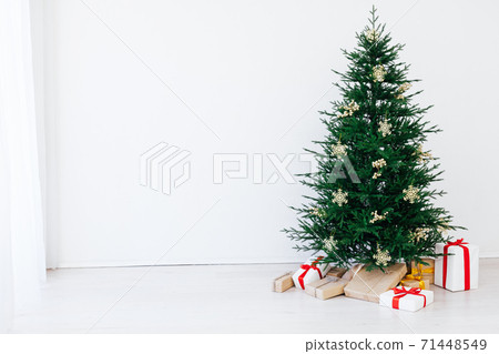 Christmas tree pine with gifts for the new year of the white room 2021 2022 Christmas tree pine with gifts for the new year of the white room 2021 2022 71448549