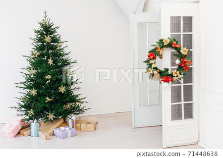 Christmas tree pine with gifts for the new year interior of the white room Christmas tree pine with gifts for the new year interior of the white room 71448638