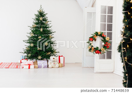 Christmas tree pine with gifts for the new year interior of the white room 71448639