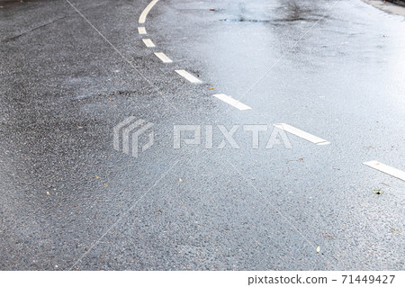 wet surface of two-lane road after autumn rain 71449427