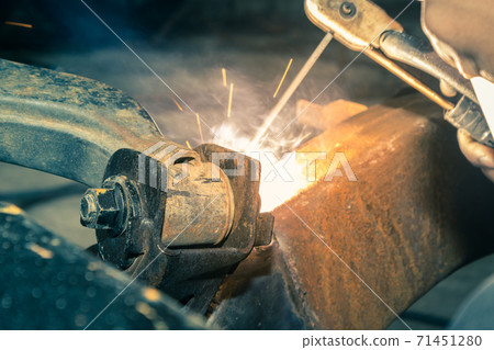 Welding Car Lower Arm by Welding Worker or Welder Man in Vintage Tone 71451280