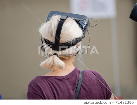 Unrecognizable woman with VR headset on street 71451390