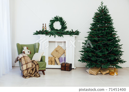 Christmas tree with gifts by the fireplace for the new year decor of the house 2021 2022 71451400
