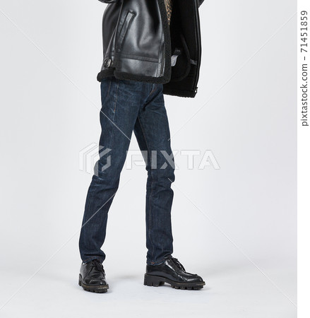 Standing man wearing blue skinny jeans, slim body 71451859