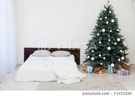 Christmas tree with gifts in the bedroom by the bed new year decor Christmas tree with gifts in the bedroom by the bed new year decor 71452890