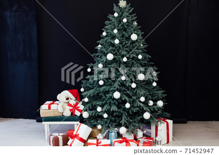 Christmas tree pine with gifts new year decor black background Christmas tree pine with gifts new year decor black background 71452947