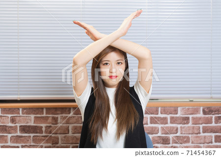Young woman making an NG gesture 71454367