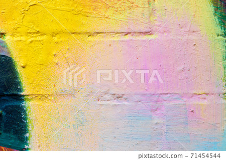A fragment of colorful graffiti painted on a brick wall. Abstract backdrop for design. A fragment of colorful graffiti painted on a brick wall. Abstract backdrop for design. 71454544
