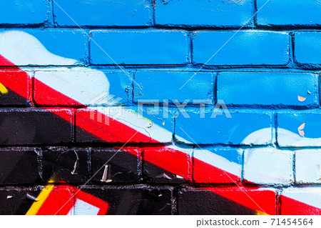 A fragment of colorful graffiti painted on a brick wall. Abstract backdrop for design. A fragment of colorful graffiti painted on a brick wall. Abstract backdrop for design. 71454564