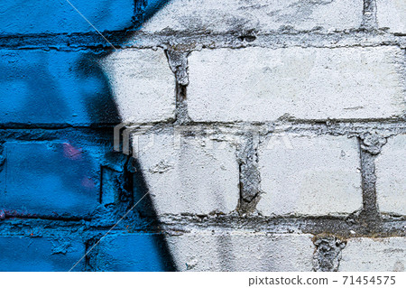 A fragment of colorful graffiti painted on a brick wall. Abstract backdrop for design. A fragment of colorful graffiti painted on a brick wall. Abstract backdrop for design. 71454575