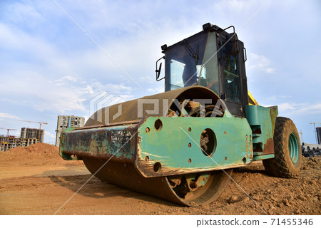 Vibro Roller Soil Compactor leveling ground at construction site.  71455346