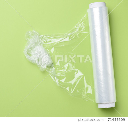 roll of transparent cling film for packaging products, green background 71455609