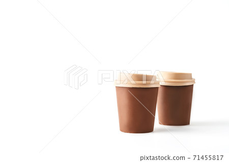 Two beautiful takeaway cups made of chocolate on isolated white background. Abstract design template on white backdrop. Food and drink concept. Coffee background. 71455817