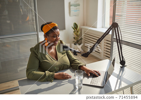 Radio host working on laptop Radio host working on laptop 71455894