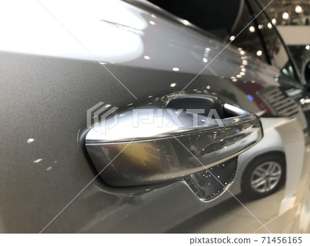 Door handle of a brand new car in the dealership, close-up shot Door handle of a brand new car in the dealership, close-up shot 71456165