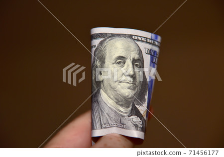 Face of the Benjamin Franklin on US hundred closeup. 100 dollars bill  71456177