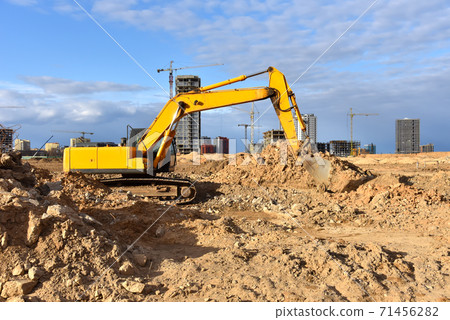 Excavator during excavation at construction site. Excavator during excavation at construction site. 71456282