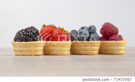 Blackberries, raspberries, strawberries, blueberries in a waffle basket. 71457087
