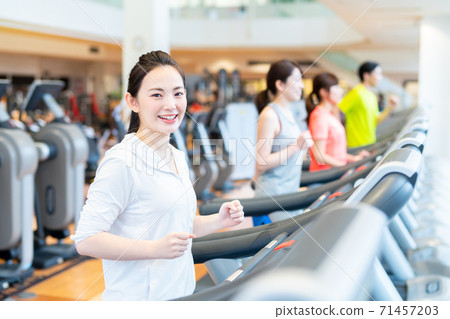 Young people exercising in the gym Young people exercising in the gym 71457203