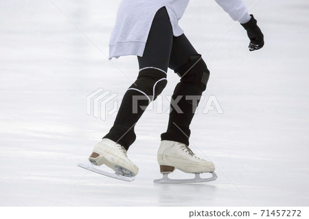 girl ice skating on an ice rink. Hobbies and sports. Vacations and winter activities. girl ice skating on an ice rink. Hobbies and sports. Vacations and winter activities. 71457272