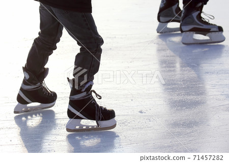 Feet skating on the ice rink 71457282