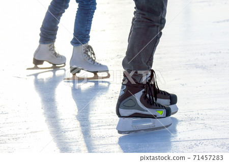 legs of a man skating on an ice rink. Sport and entertainment. Rest and winter holidays legs of a man skating on an ice rink. Sport and entertainment. Rest and winter holidays 71457283