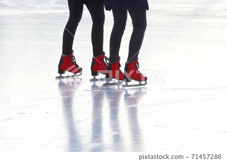 feet in red skates on an ice rink feet in red skates on an ice rink 71457286