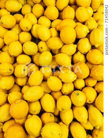 lots of ripe sour lemons to eat as a background 71458042
