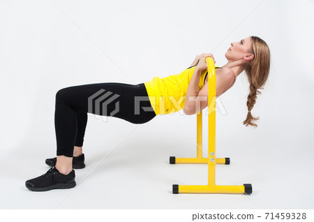 Woman doing exercises with high yellow floor bars on a white background Woman doing exercises with high yellow floor bars on a white background 71459328