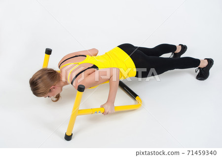 Woman doing exercises with high yellow floor bars on a white background Woman doing exercises with high yellow floor bars on a white background 71459340