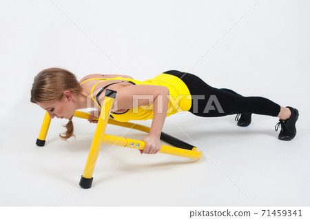 Woman doing exercises with high yellow floor bars on a white background Woman doing exercises with high yellow floor bars on a white background 71459341