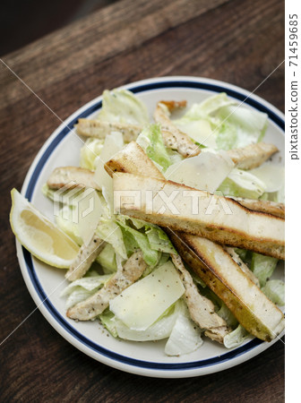 simple healthy chicken caesar salad on wood table 71459685