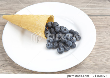 Blueberries in a waffle basket. Vitamins and wholesome foods Blueberries in a waffle basket. Vitamins and wholesome foods 71460075