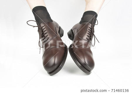 Male legs in socks and brown classic shoes on a white background 71460136